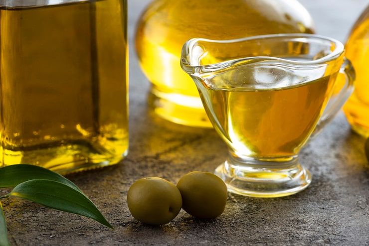 Foto gratuito close-up taza de aceite de oliva y aceitunas verdes