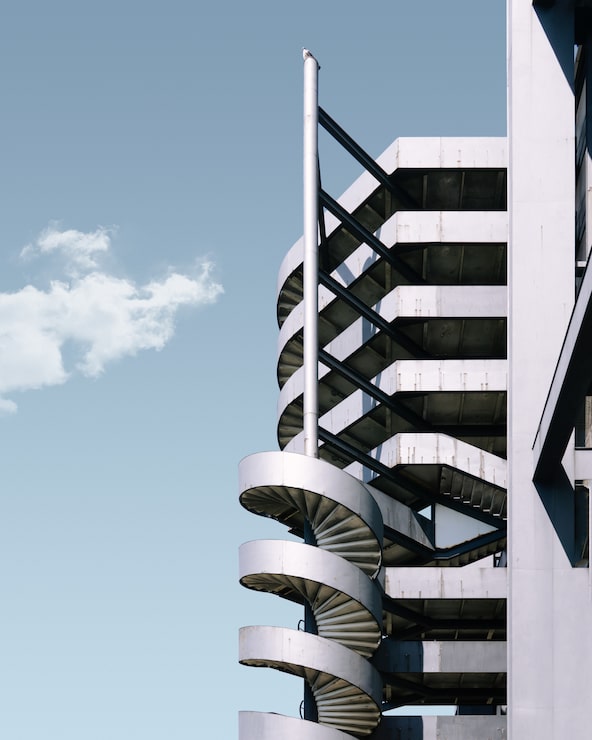 Foto gratuito edificio de metal y la escalera bajo el cielo azul