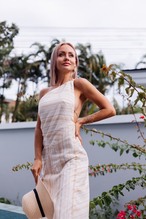 Foto gratuito feliz linda mujer caucásica romántica en elegante vestido blanco con espalda abierta y sombrero de paja