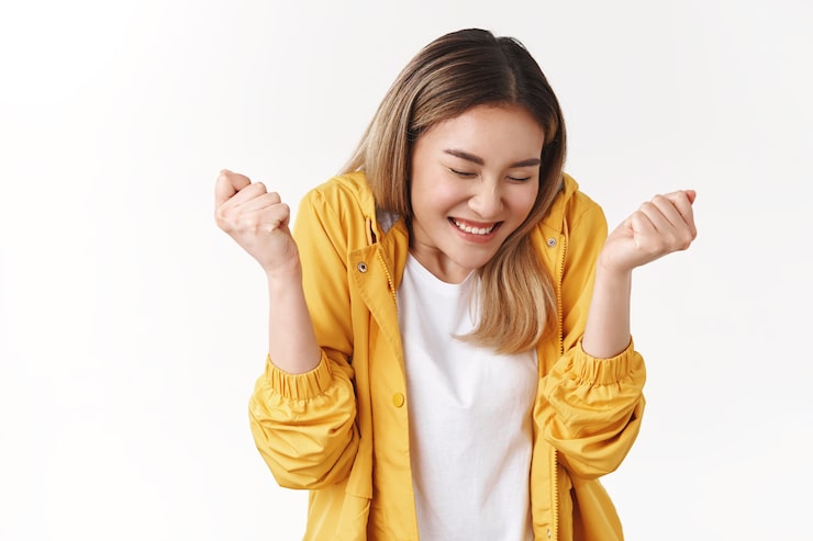 Photo Gratis gadis asia berambut pirang yang ceria dan imut merasa sangat bahagia dan sukses menari menutup mata tersenyum lebar meremas tangan menaklukkan merayakan kemenangan berita yang sangat baik skor sempurna mencapai tujuan