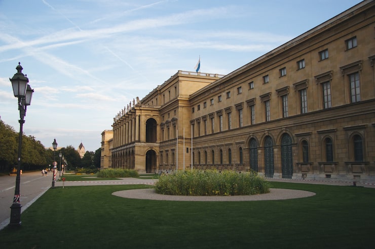Foto gratuito hercules hall rodeado de vegetación bajo la luz del sol durante el día en munich en alemania