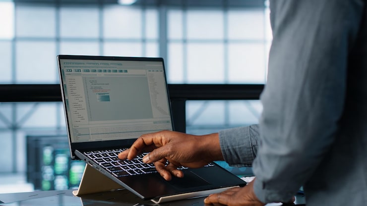 Photo Gratis insinyur pusat data membuat kode pada notebook menyesuaikan pengaturan daya