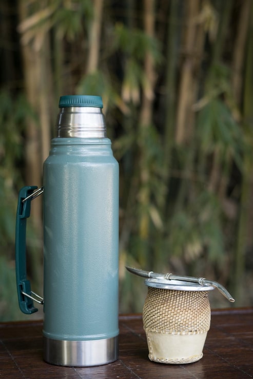 Foto gratuito primer plano vertical de una taza de infusión de yerba mate con un termo.