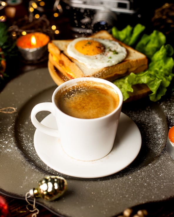 Foto gratuito taza de café y sandwich con huevo