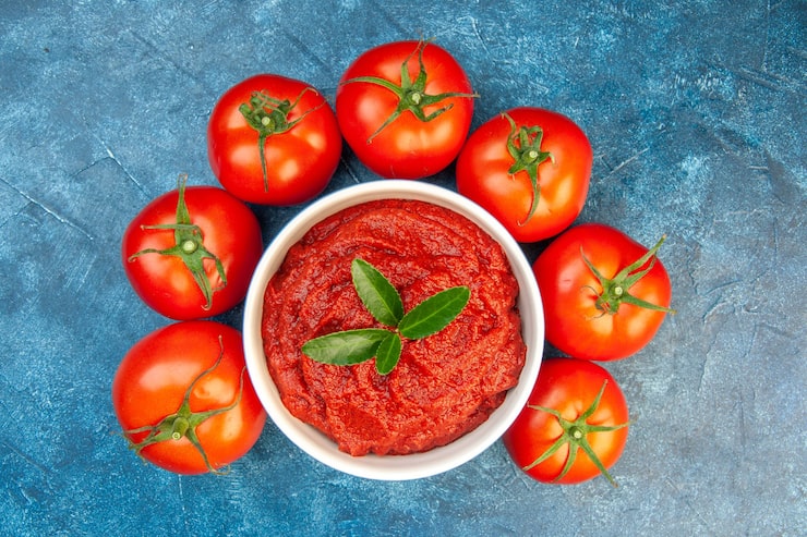 Foto gratuito vista superior de tomates frescos con pasta de tomate en mesa azul