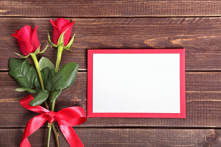 Foto gratuito carta di san valentino con rose rosse su tavola di legno