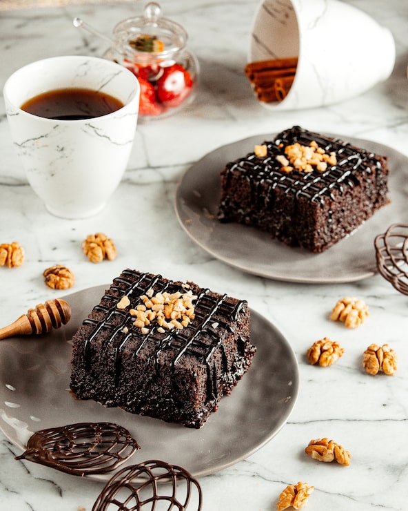Foto gratuito vista laterale di torte al cioccolato sul piatto servite con il tè su un tavolo di marmo