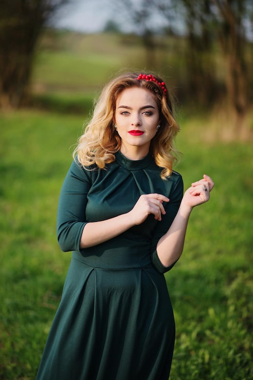 Foto grátis garota loira de elegância yong no vestido verde no jardim na primavera