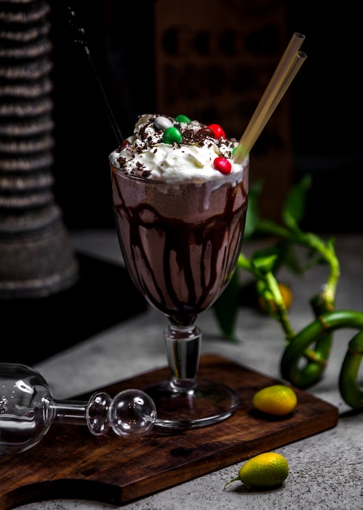 Foto grátis milk-shake de chocolate com chantilly e doces por cima
