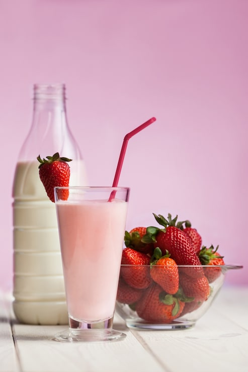 Foto grátis smoothie de morango em madeira branca