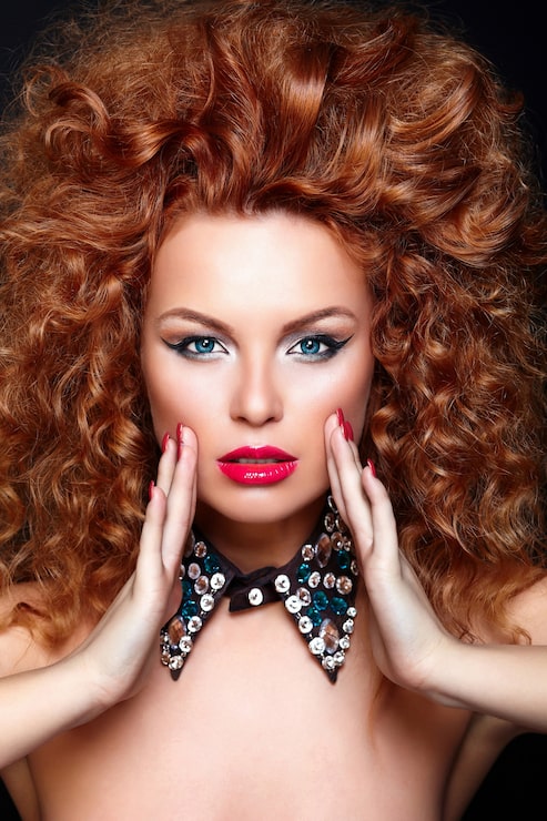 Kostenlose Foto high fashion look.glamour nahaufnahme porträt der schönen sexy rothaarigen kaukasischen jungen frau modell mit roten lippen, helles make-up, mit perfekter sauberer haut mit schmuck auf schwarz isoliert