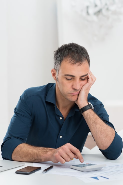 Foto hombre cansado haciendo cálculos