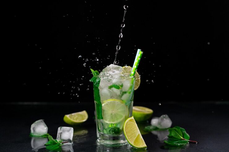 Foto um fluxo de água em um copo de mojito contra um fundo preto