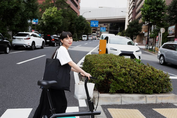 무료 Photo 도시에있는 전기 자전거를 가진 여자