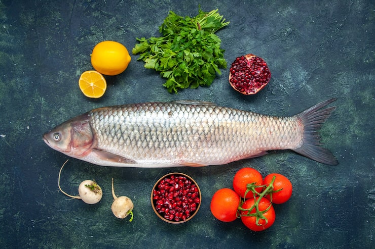 Gratis Foto topputsikt rå fisk tomater reddik persille granateple i liten skål sitron på kjøkkenbord