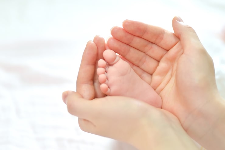Gratis Foto babyfødder i mors hænder.