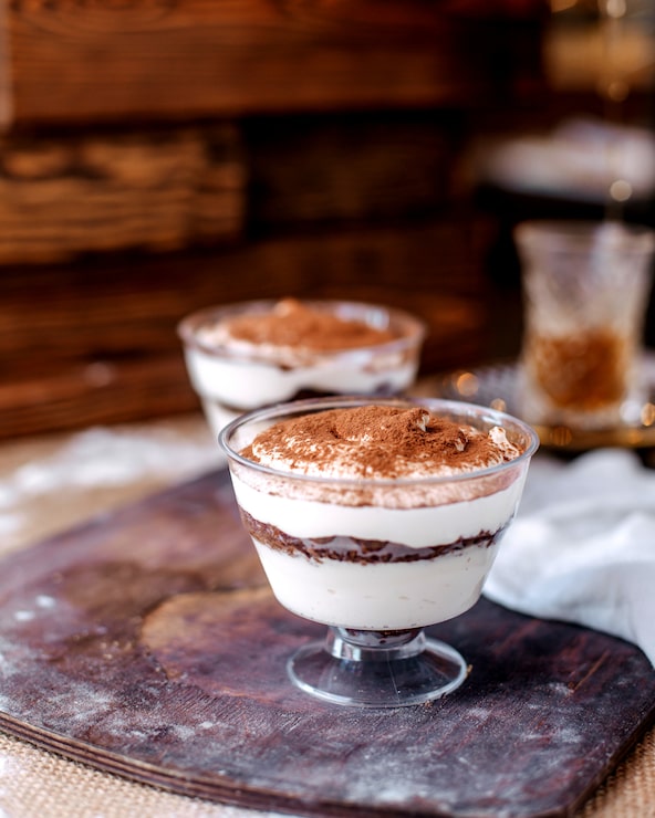 Gratis Bild framifrån vy av vit läcker dessert inuti små glas på det bruna skrivbordet