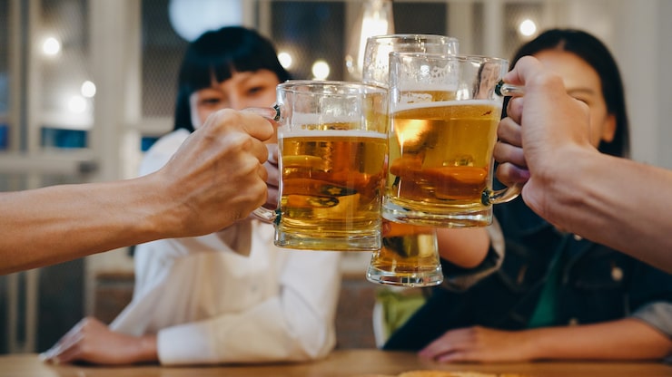 Gratis Bild grupp av glada turister, unga asiatiska vänner, dricker alkohol eller hantverksöl och har en hangout-fest på en nattklubb på the khao san road.