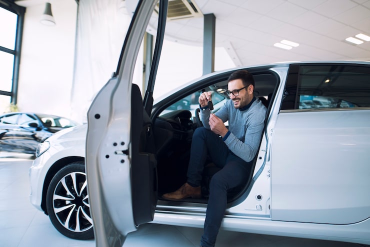 Photo gratuit acheteur de voiture tenant les clés du nouveau véhicule et souriant