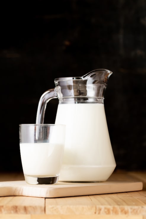 Photo gratuit lait en verre et pot sur la table en bois
