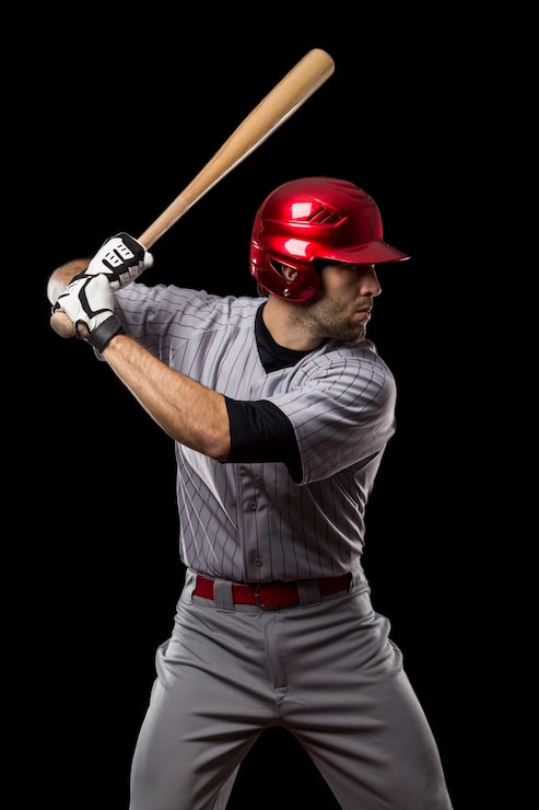 Photo joueur de baseball sur fond noir. prise de vue en studio.