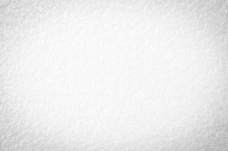 Kuva teksturoitu valkoinen kuplamuovitausta pehmeällä kulmavinjettauksella.