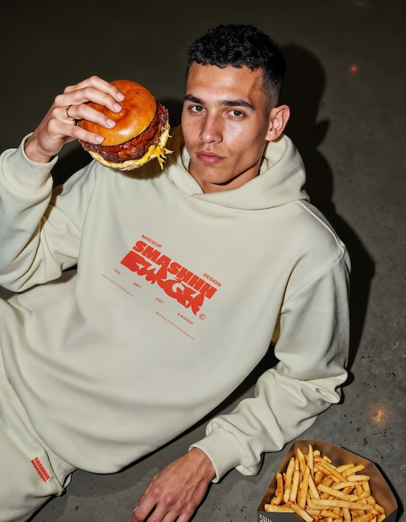 Man holding a burger mockup with fries