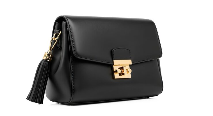 PSD un sac à main en cuir noir avec un fermoir doré et une pampille